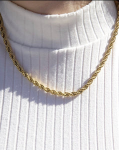 a person wearing 18 karat gold plated rope chain