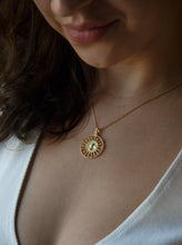Load image into Gallery viewer, woman wearing 18 karat gold plated silver round necklace with a bird in the middle
