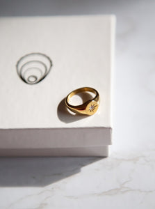 18 karat gold plated signet ring with cubic zirconia stone in the middle